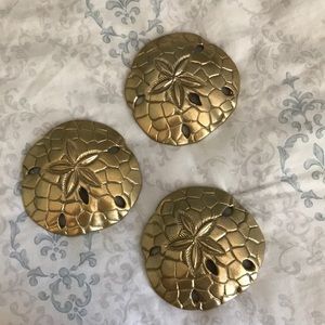 Three gold decorative sand dollars
